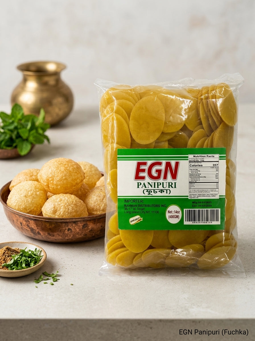 A clear plastic bag of EGN Panpuri (Indian fried potato chips) with a green and white label, displayed on a light marble surface next to a copper bowl filled with golden fried snacks, garnished with herbs, and set against a neutral background.