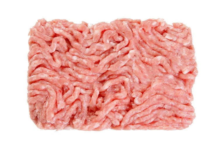 A pile of raw zabiha halal ground chicken breast meat.