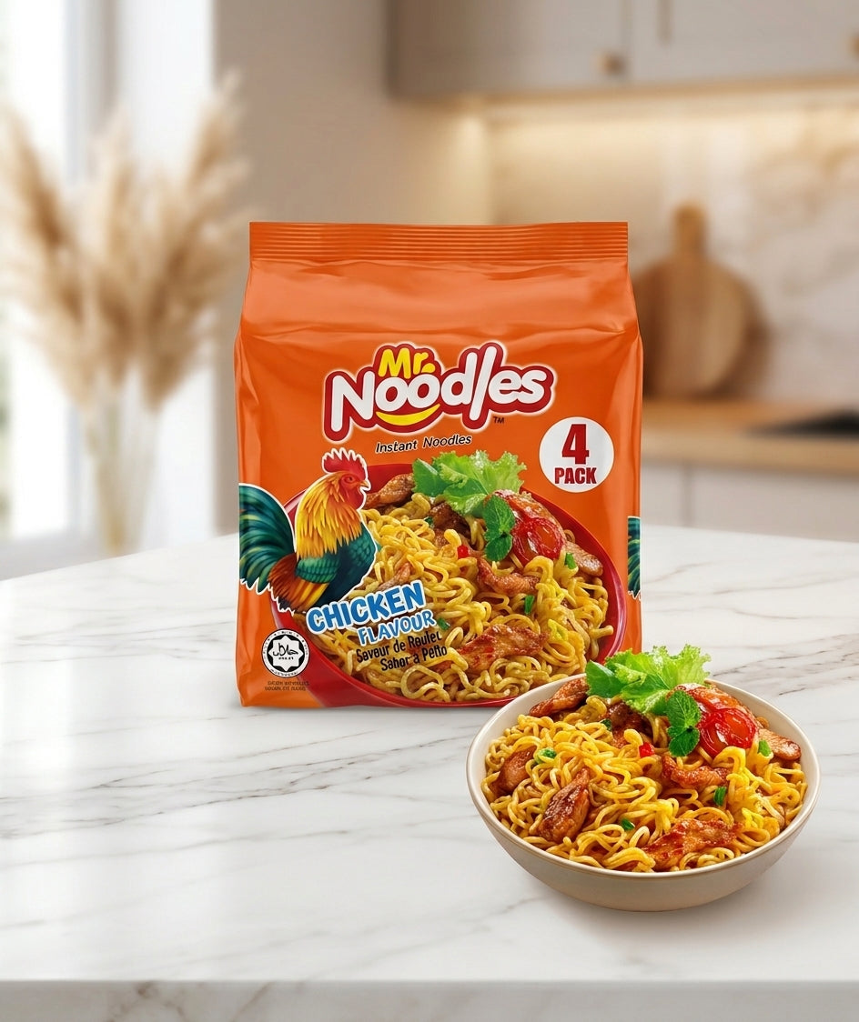 A bag of Mr. Noodles Chicken Flavor instant noodles stands on a white marble countertop with a bowl of prepared noodles in front, set against a softly blurred kitchen background.
