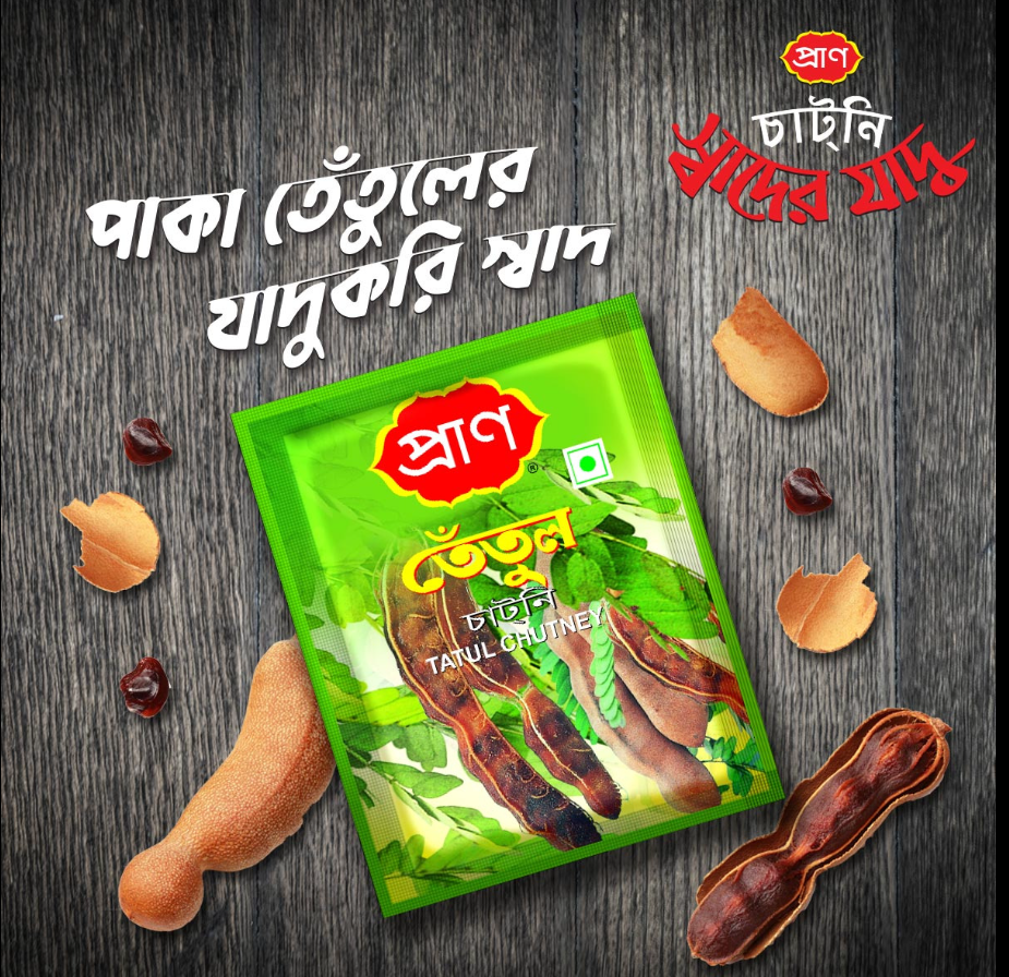 Green packet of tamarind chutney with tamarind seeds on a wooden background