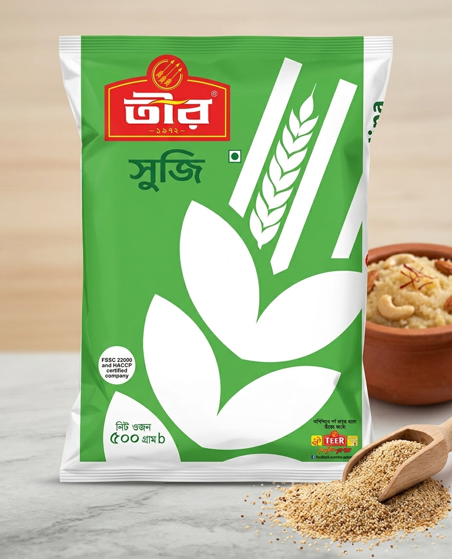A package of Tuir Suji (wheat flour) in a green and white bag, displayed on a marble surface with a bowl of prepared suji dish and a wooden spoon of loose flour in the background.