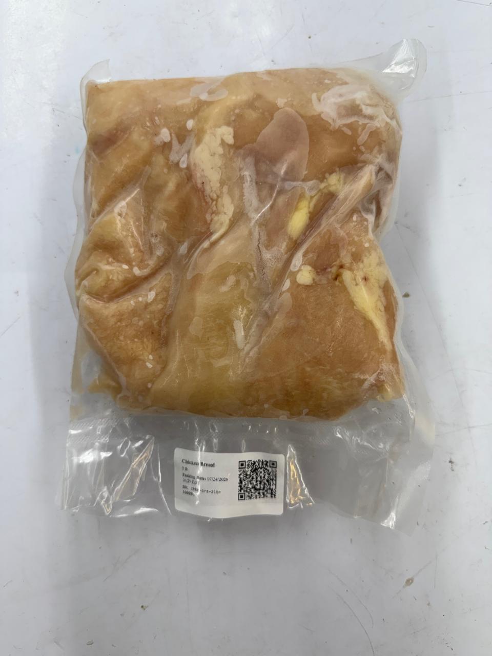 A vacuum-sealed package containing Raw  Zabiha Halal chicken breast cutlets, with a small white label and QR code near the bottom, set against a light gray background.