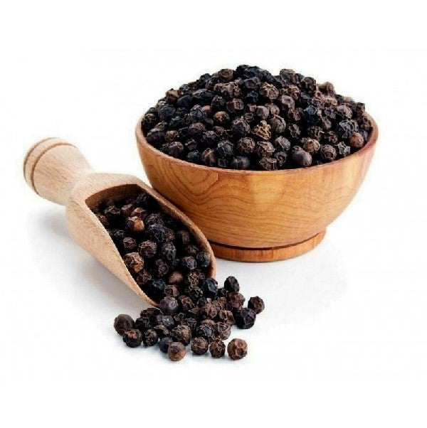Wooden bowl and scoop filled with black peppercorns on a white background