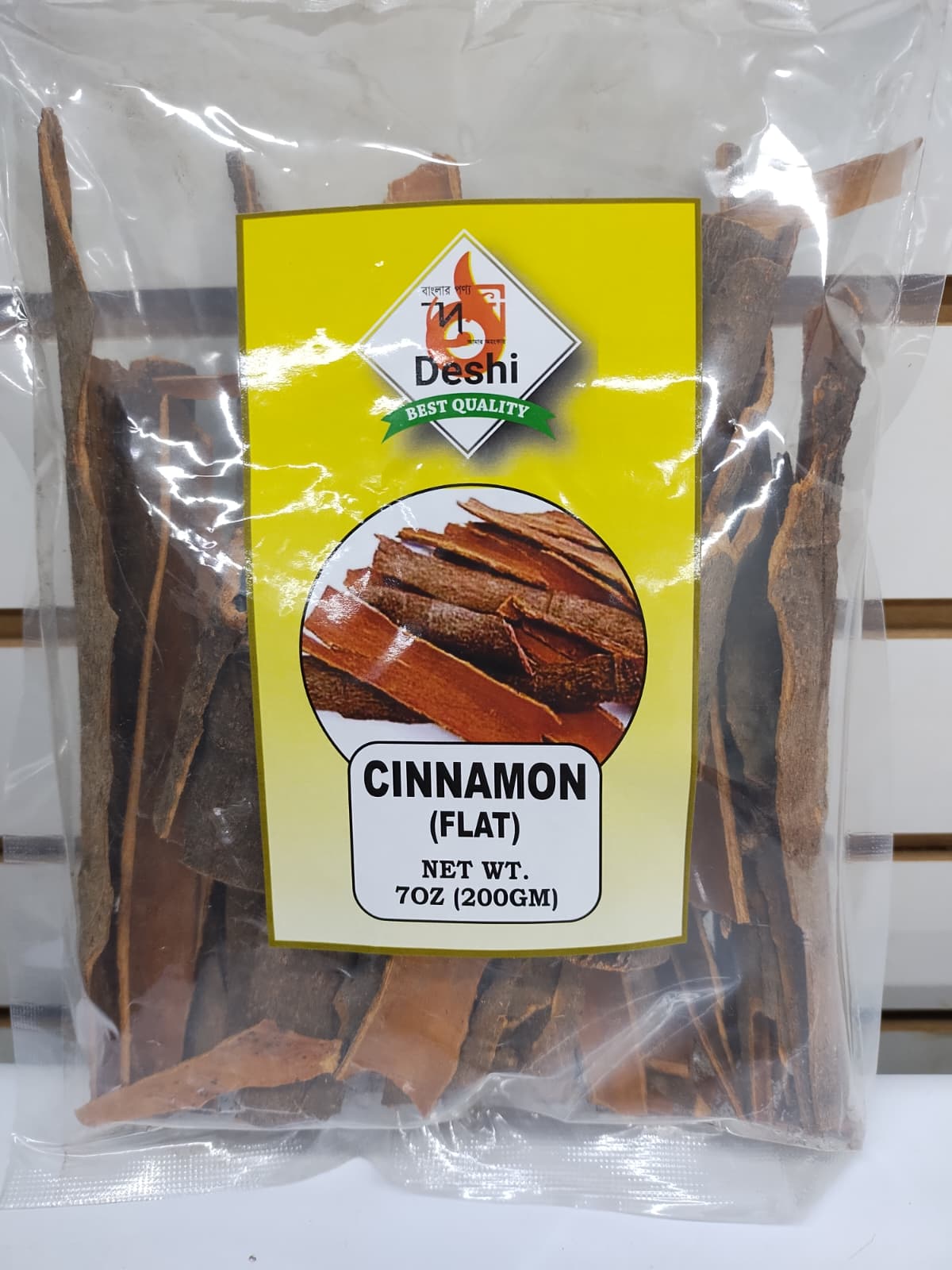 Packaged cinnamon sticks with a yellow label on a white background