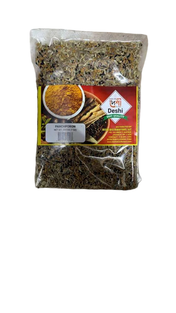 A clear plastic bag of Dishi Organic Whole Turmeric Root, showing the dried green and yellow-brown turmeric pieces inside, with a red and yellow label on a light gray textured surface.