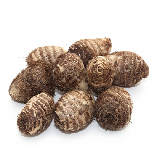 A pile of fresh, raw taro yams with rough, textured brown and beige skins, isolated on a white background.