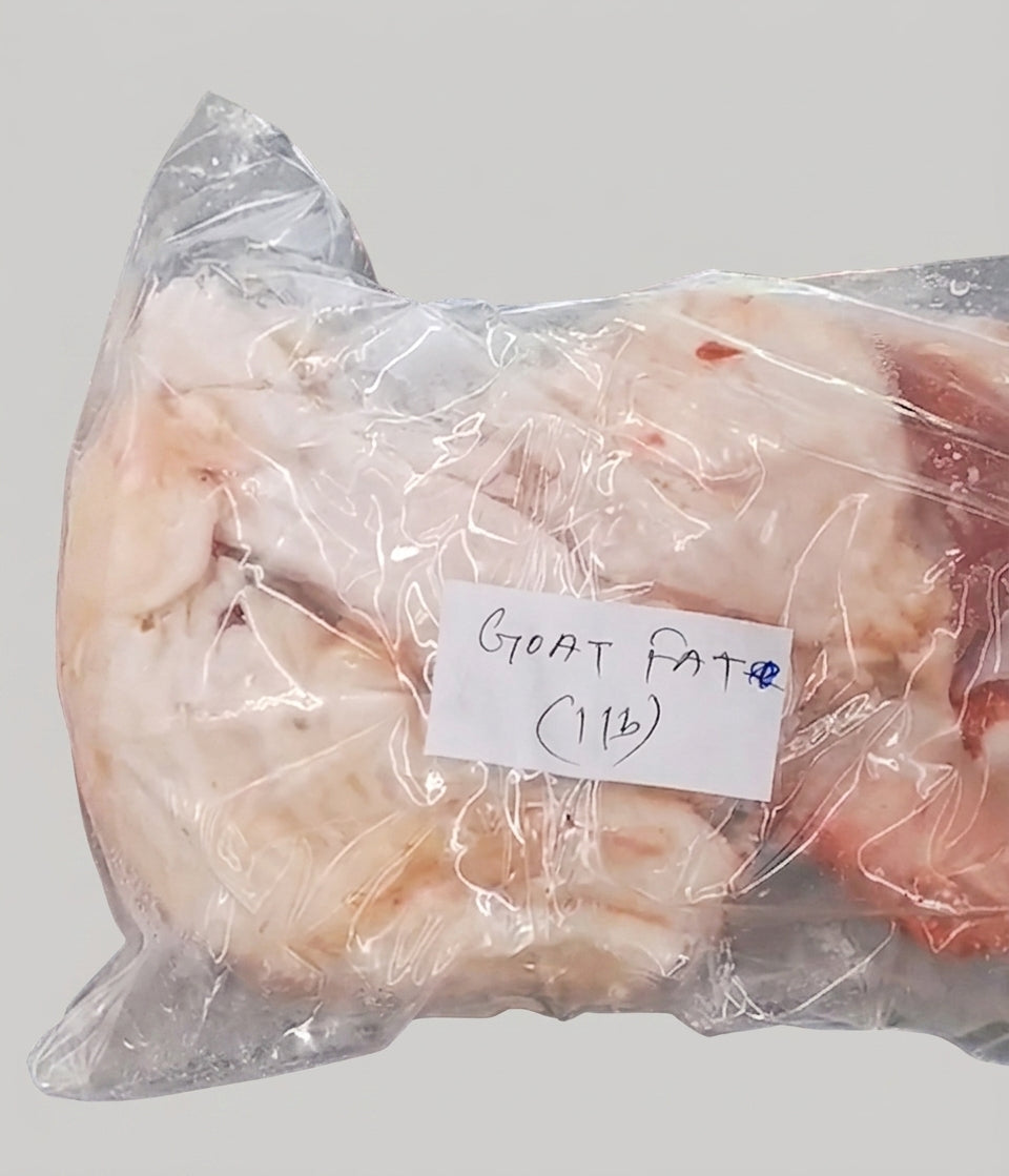 A vacuum-sealed clear plastic bag containing pale off-white meat pieces, with a handwritten white label reading 'GOAT FAT (1lb)' on a light gray background.