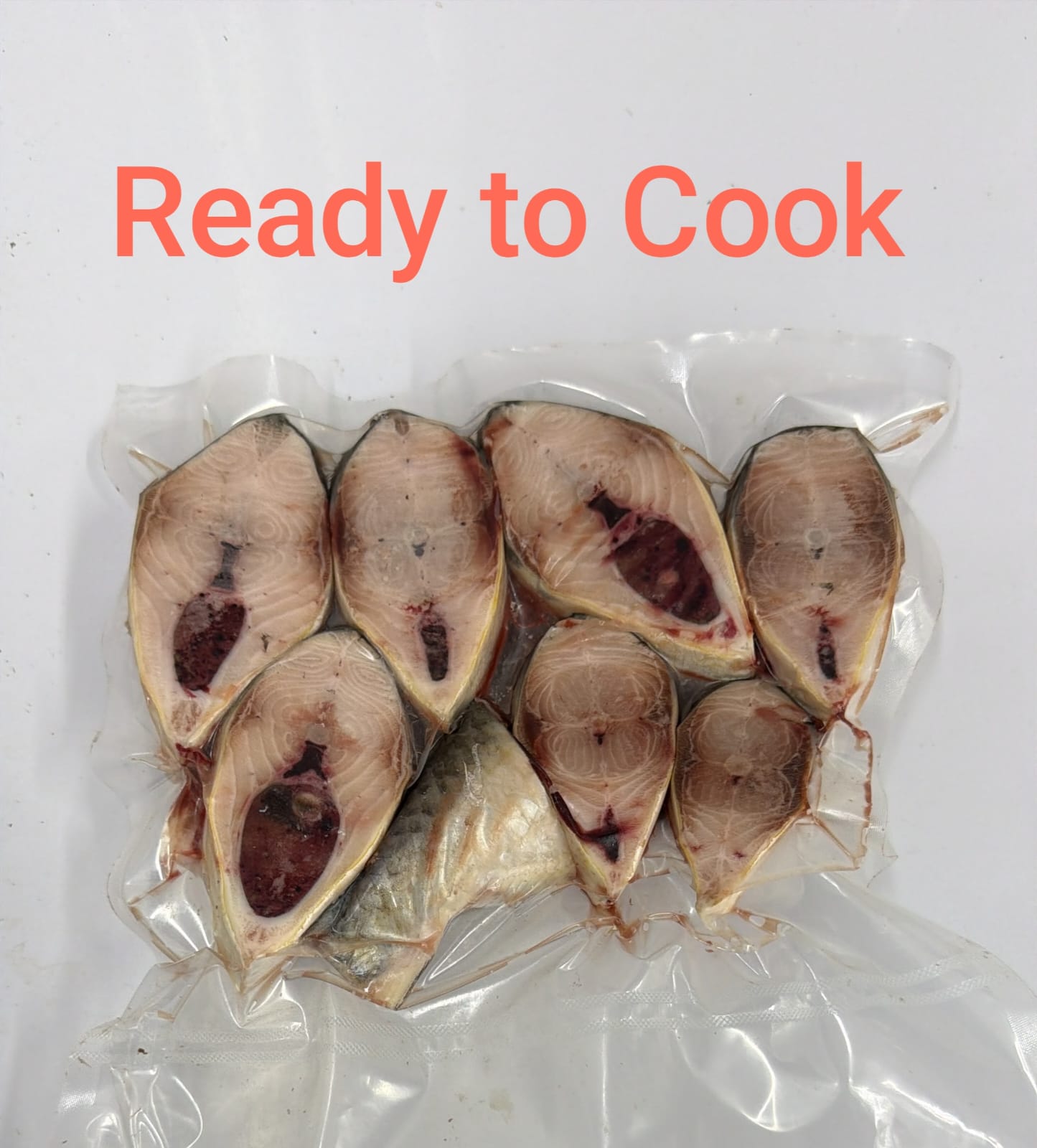 Several cut fish fillets sealed in a clear plastic bag on a white background, with the red text 'Ready to Cook' above them.