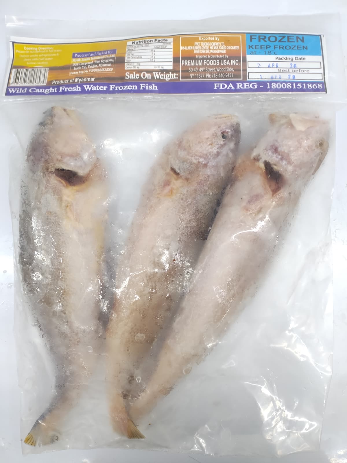 Three frozen fish in a clear plastic bag with a label on a white background