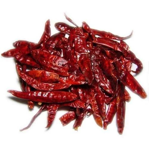 Pile of dried red chili peppers on a white background